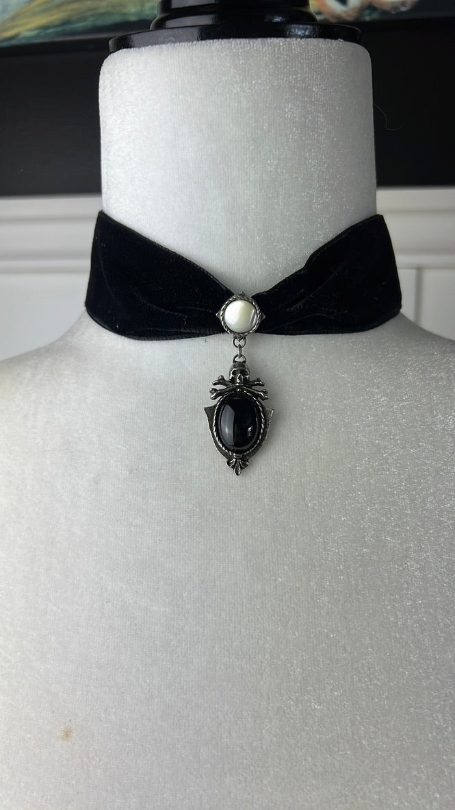 Black Eretica choker with pearlescent button and skull and crossbones detail